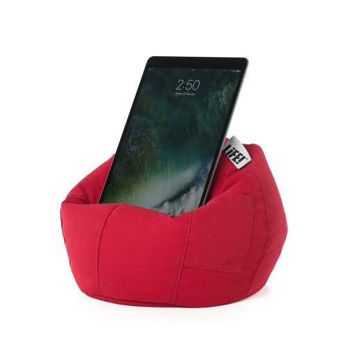 An iPad, tablet or mobile device rests on the bright scarlet red iCrib tablet holder, iPad stand, book rest. A storage pocket can be seen.